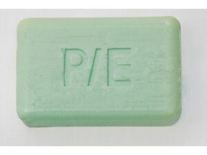 A rectangular green bar of soap with the letters "P/E" engraved on its surface.