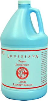A large light blue plastic jug labeled "Louisiana Prison Enterprises Liquid Laundry Bleach" with a handle and red text.