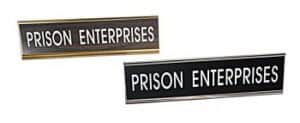 Two rectangular Nameplate Holders show "PRISON ENTERPRISES" in white caps on dark backgrounds with metallic borders.