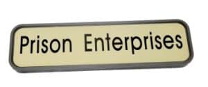 A Modular Wall Frame w/ Nameplate featuring "Prison Enterprises" in bold black letters on a light background.