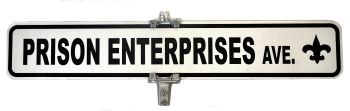 A street sign reads “PRISON ENTERPRISES AVE.” with a fleur-de-lis symbol on the right side.