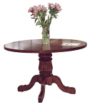 A Circular Conference table 48x30 with a vase of pink flowers and a piece of paper resting on top.