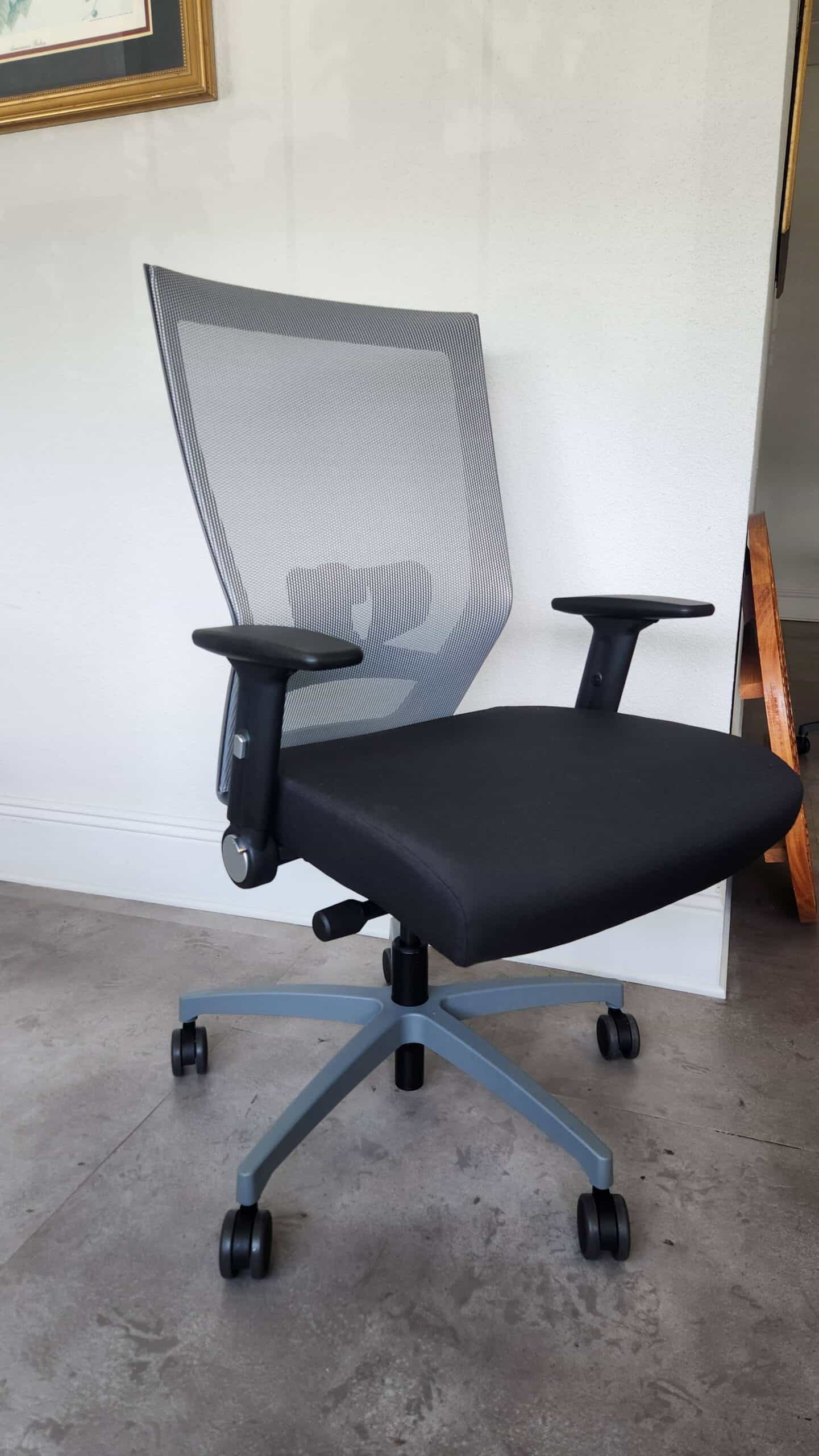 The Eclipse II Plus High Back Task Chair features a black mesh back, black seat, adjustable arms, and a gray base with five casters.