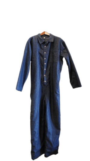 The Long Sleeve Blue Denim Jumpsuit features a chest pocket and button-down front, displayed on a wooden hanger.
