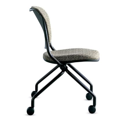 Side view of the Navigator-armless-upholsterable back chair with fabric seat, black metal frame, and four caster wheels.