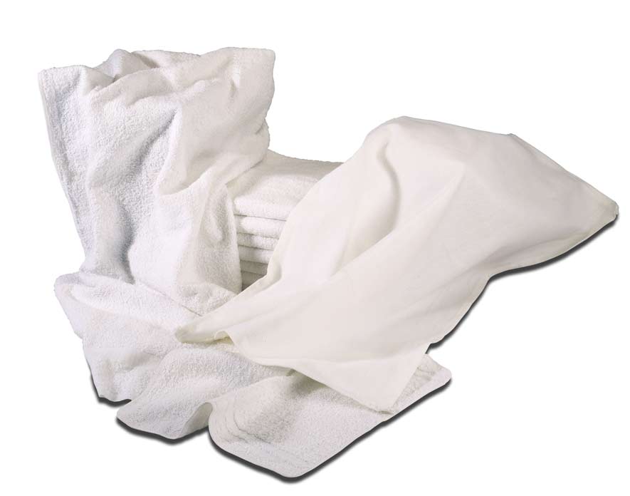 A stack of folded white Terrycloth Washcloths 12x12 with extra washcloths and a white sheet draped in front and on the sides.